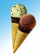 Two ice cream cones with scoops of ice cream