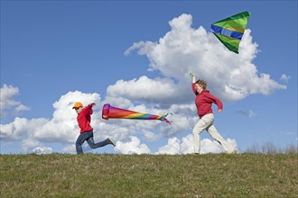 Mother and son flying a kite and a windsock