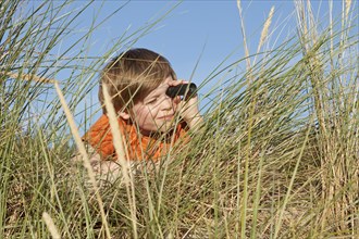 Boy in the dune grasses