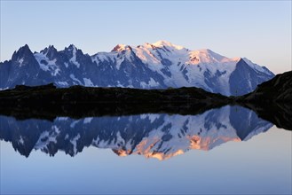 Mont Blanc massif at sunrise reflected in Lac de Chesserys