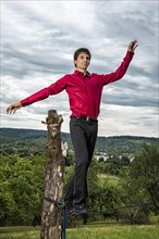 Young man balancing on slackline