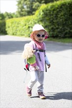 Toddler hiking with doll