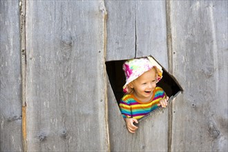 Toddler happily looking out of a window