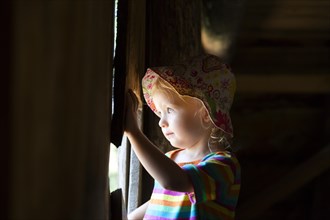 Toddler looking out of a window
