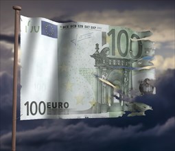 Torn euro flag in front of cloudy sky
