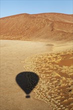 Shadow of a hot-air balloon in the Namib Desert