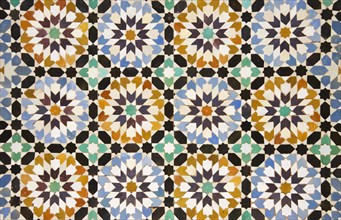 Detail of colourful geometric zellige tileworks in the central courtyard of the Ben Youssef Madrasa