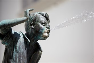 Fountain statue spewing water out of mouth