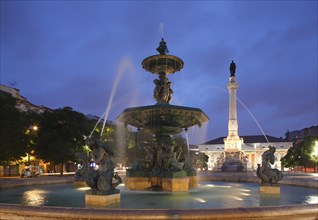 Bronze fountain monument Pedro IV. on Rossio square at dusk