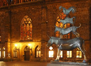 Bremen Town Musicians with illuminated windows of the Church of Our Lady