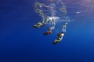 Freedivers with underwater scooters