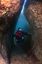 A diver inspecting an underwater cave