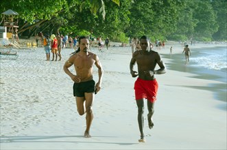 Two Creole men on a morning jog along the beach
