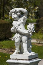 Clay statue of a boy with flowers