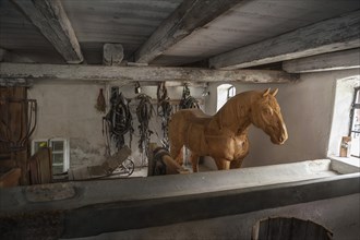 Wooden horse in the horse barn