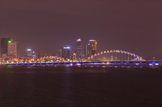 Illuminated Cáº§u Rá»“ng or dragon bridge over the Han River at night