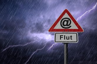 @ symbol and Flut road signs againt a rainy sky with lightning