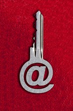 @ sign key against a red background