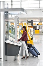 Woman with luggage at the InfoGate