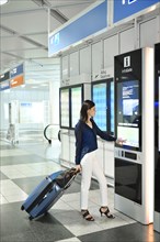 Woman with luggage at the InfoGate