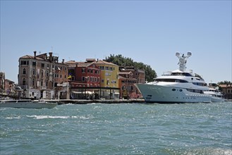 Large yacht in front of houses by San Marco basin