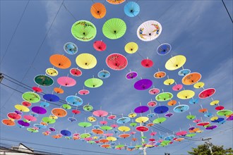 Many colourful umbrellas suspended in mid-air