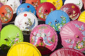 Handmade paper parasols drying in the sun at an umbrella factory in Bo Sang