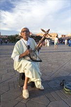 Music player playing a traditional Moroccan music instrument