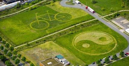 Bicycle and Yin Yang symbol mowed into a meadow