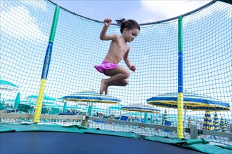 Kid jumping on a trampoline