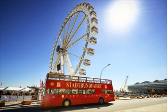 Bus for city tours and ferris wheel at the cruise terminal