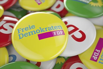 German political party FDP button in front between other governing party buttons