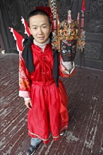 Mask dancer in Ci-Yun Temple holding a traditional mask