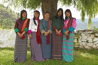 Young women wearing colorful Kira dresses