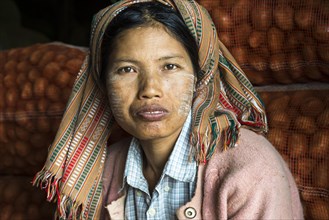 Woman with Thanaka paste on her face during the potato harvest