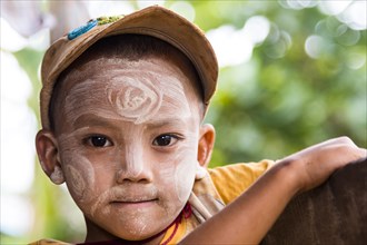 Child with Thanaka paste in the face of mountain tribe or mountain people Pa-O or Pa-Oh or Pao or Black Karen or Taungthu or dew-soo