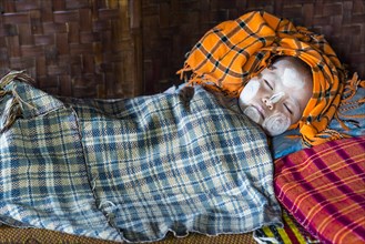 Sleeping child with Thanaka paste on the face