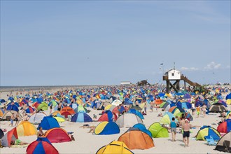 Many bathers with beach tents on the beach