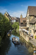 Timbered houses and canal with excursion boat