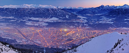 Innsbruck covered in snow at dusk