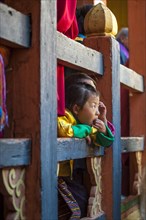 Children watching the happenings of a temple festival at Jakar Dzong