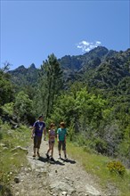 Hikers at the Cirque de Bonifatu Boucle de Ficaghiola at the long-distance trail Tra Mare e Monti and GR20