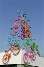 Sculpture with colourful bikes on bike path