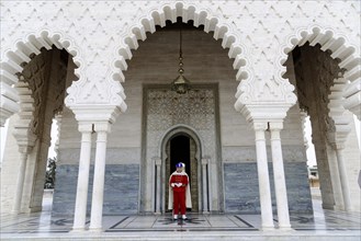 Guard in traditional uniform at the gate of the Mausoleum Mohammed V and Hassan II