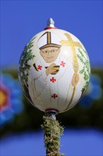 Pope Francis on a painted Easter egg of an Easter well