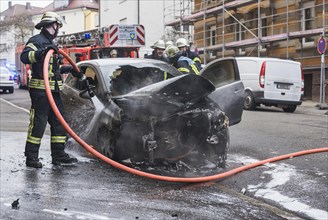 Fire department extinguishing a burning Corsa