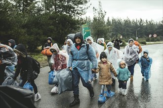 Incoming refugees in rain