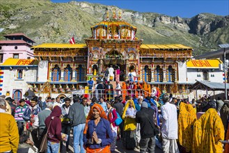 Many pilgrims are gathering in front of the colourful Badrinath Temple