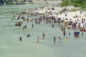 Pilgrims are taking bath at the banks of the holy river Ganges