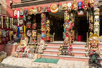 Colorful wooden masks and other souvenirs are sold in a shop